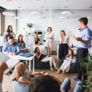 Business man makes a presentation in the office standing behind