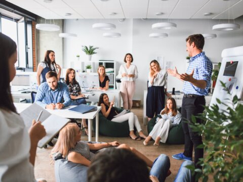 Business man makes a presentation in the office standing behind