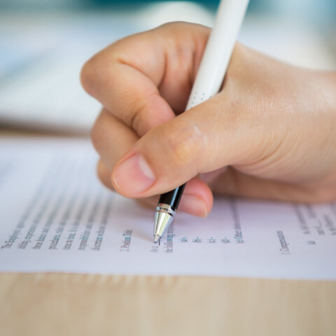 Close up of hand completing an employment application form